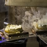 Jeder Frischkäse wird für 20 Sekunden auf einem Rost liegend durch den Rauch geführt. Danach hat der Rygeost ein dezentes Raucharoma / © Foto: Georg Berg