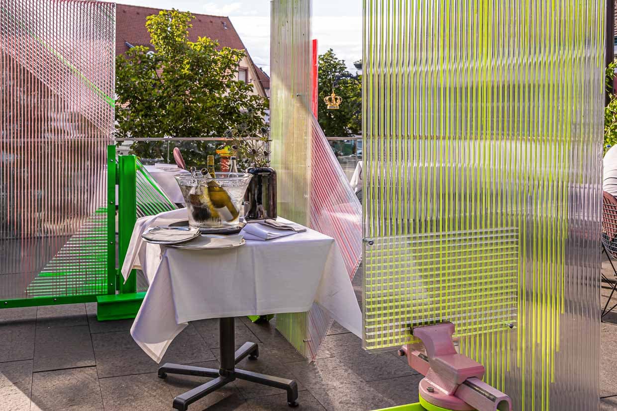 Kunst in Zeiten von Corona. Der Künstler Samuel Treindl entwarf einen Spuckschutz. Schutz und Zierde zugleich für die Terrasse im Restaurant Krone / © Foto: Georg Berg