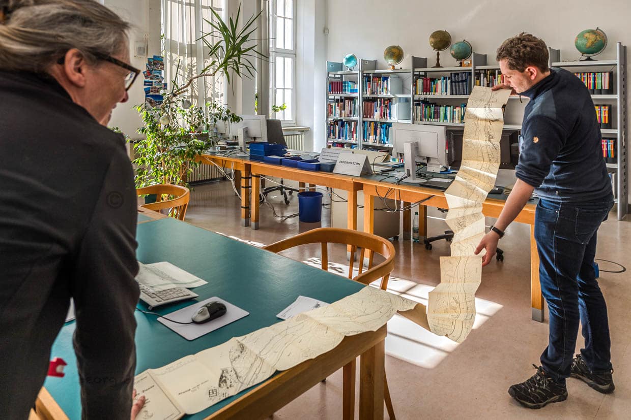 Mann betrachtet eine gefaltete Karte in einem Büro in Leipzig, Deutschland