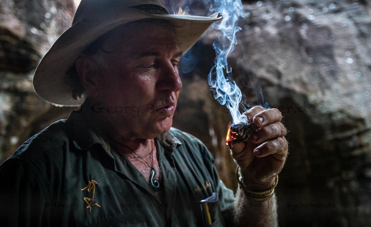 Sab Lord zündet ein von Termiten bearbeitetes Stück Holz an. Ein altes „Hausmittel“ der Aborigines, um mit dem Rauch die Mücken zu vertreiben / © Foto: Georg Berg
