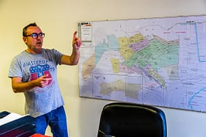 Manager Yann Fernandez zeigt am Lageplan von Taurrenne die Anpflanzungen. Jede Farbe steht für eine andere Olivenbaumsorte. Und jede Sorte hat einen anderen Erntezeitpunkt / © Foto: Georg Berg