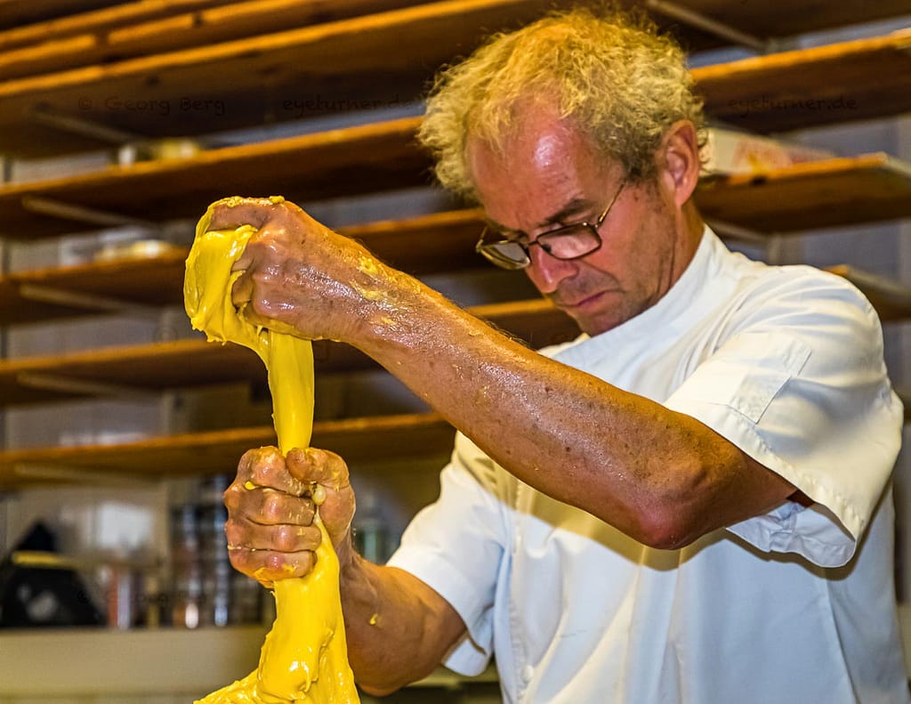Elastisch, glänzend und gelb. Mit bloßen Händen teilt Arno Antongnini den Vorteig für die unterschiedlichen Panettone-Sorten Tradizionale, Nostrano und Pandananas / © Foto: Georg Berg
