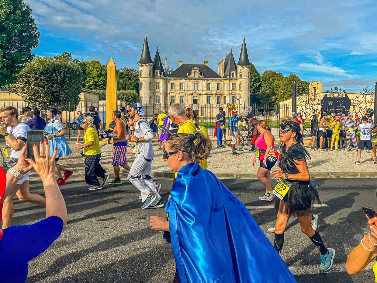 Le peloton coloré dans un décor historique. Sur le parcours du marathon, les participants du 36e Marathon des Châteaux du Médoc passent devant 25 domaines viticoles au total. Souvent, ils passent au milieu des châteaux et se voient offrir du vin rouge et de l'eau / © Photo : Georg Berg