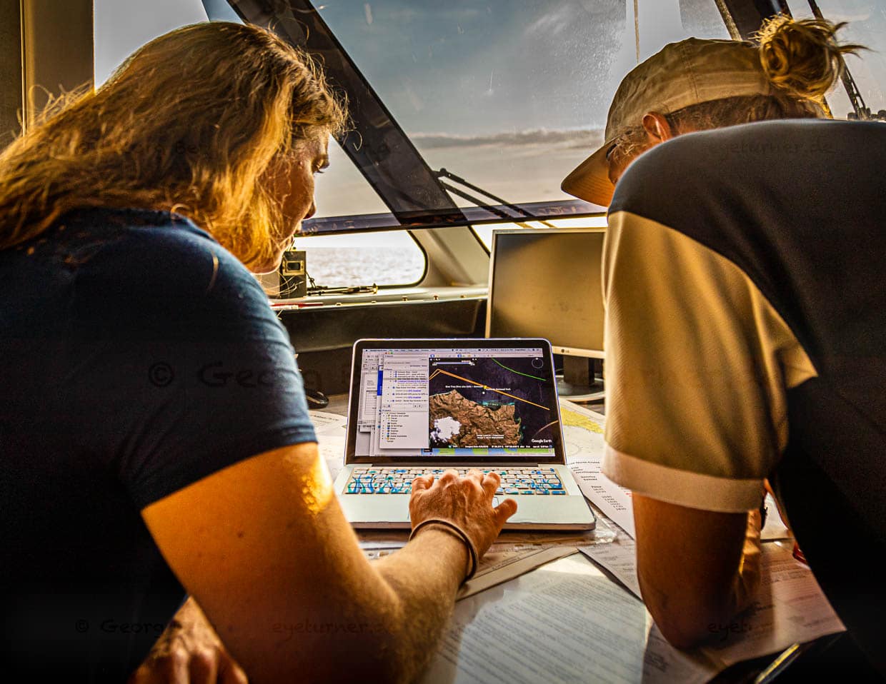 Angela und Jeremy planen auf der Brücke der True North anhand von Seekarten und Online-Informationen die Tauchgänge des nächsten Tages / © Foto: Georg Berg
