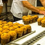 Die kleinen voran! Mini-Panettone verlassen als erstes den Backofen und werden zum Abkühlen auf ein Gestell gespießt / © Foto: Georg Berg