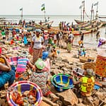Rollenverteilung im Hafen von Tombo Bay, Sierra Leone. Frauen warten auf die Fischer und ihren Fang. Der einzige Weiße auf diesem Bild: Christiano Ronaldo (CR7) isoliert von den Anderen gedruckt auf einem T-Shirt / © Foto: Georg Berg