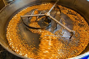 In einer Kaffeeröstmaschine werden die Maiskörner bei 200 Grad geröstet. Wenn rund 1/3 der Körner gepoppt sind, ist der perfekte Röstgrad für Farina Bona erreicht / © Foto: Georg Berg