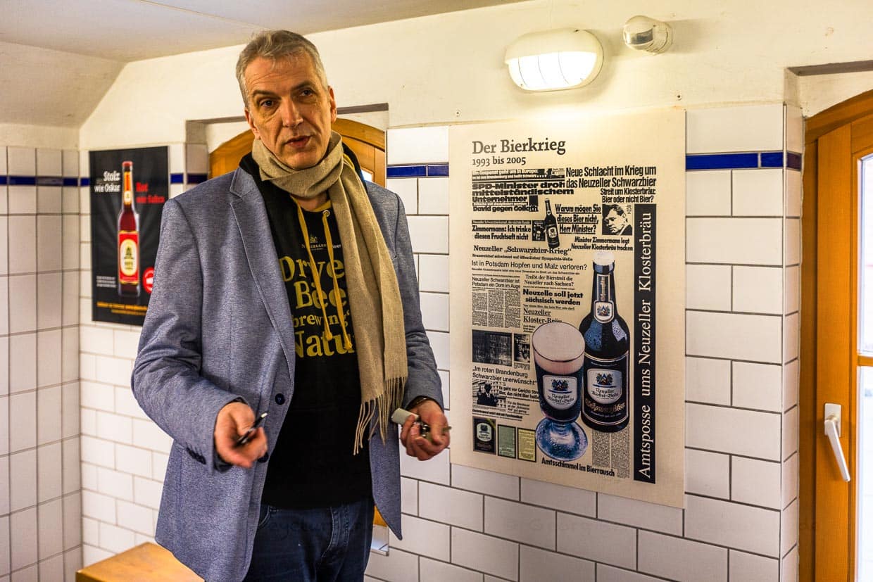 Stefan Fritsche vor den Schlagzeilen des 13 Jahre dauernden Bierkriegs, einem Rechtsstreit, den sein Vater von 1993 bis 2005 erfolgreich gegen das Land Brandenburg bestritten hat / © Foto: Georg Berg