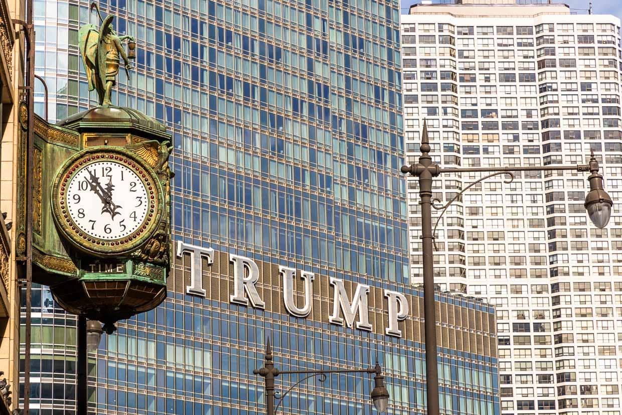 Trump Tower Chicago at the DuSable Bridge and opposite an old street clock with the time display